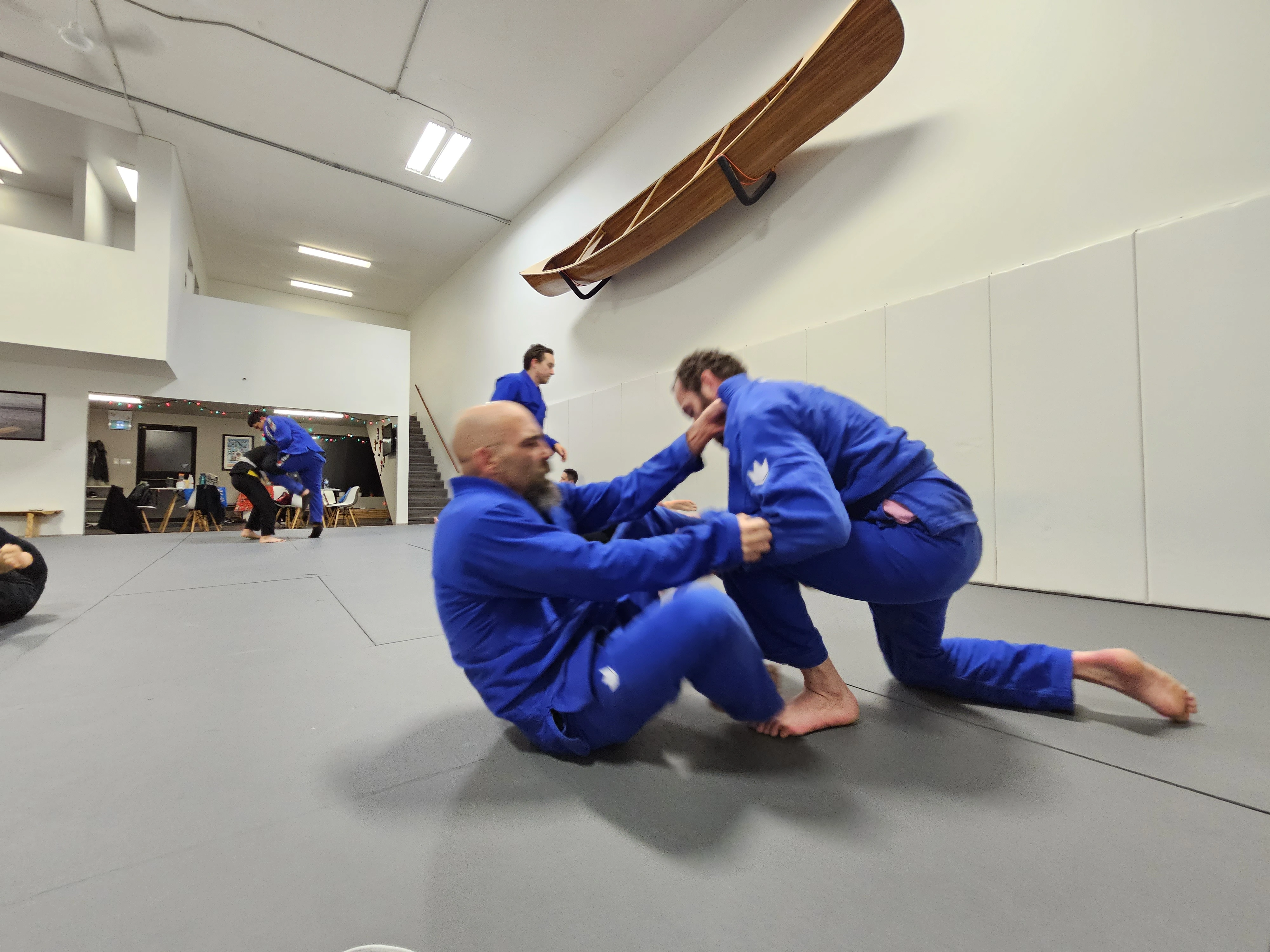 Instructor demonstrating GI Brazilian Jiu-Jitsu technique at Expedition BJJ in Regina